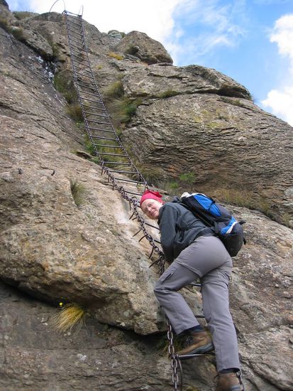 climbing down the steep rocks on a chain ladder