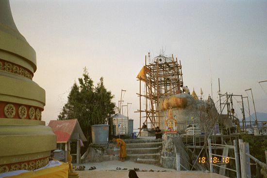 The scaffold in the background is a Buddha construction on the top of the mountain.