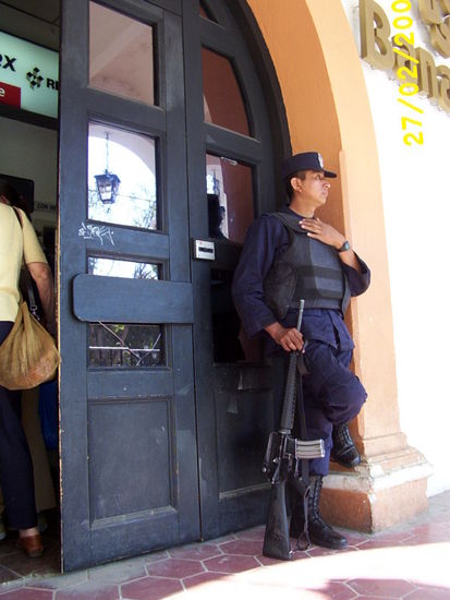 ...bored armed guard is more decoration than the bank protection...