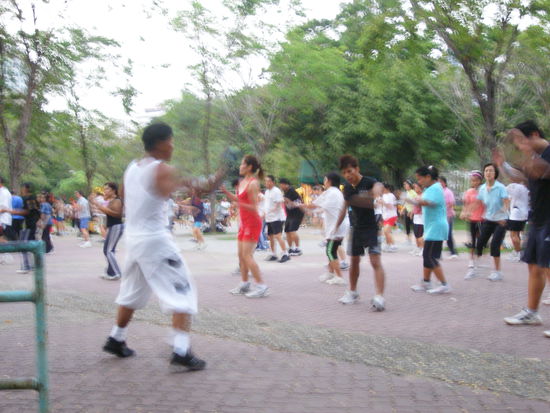 Bangkok residents sweat it out during group aerobics in Lumpini Park.