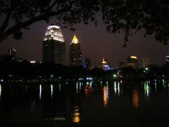 Bangkok skyline at nightfall from Lumpini Park.