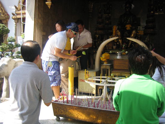 We take turns burning some incense, a candle and a flower as offerings to the Buddha