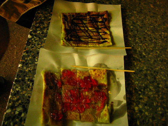 Pancake with chocolate syrup and pancake with strawberry jam