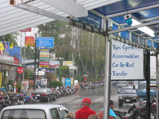 As we're leaving for the airport, it starts to POUR (notice the guy across the street running in his Speedo?)