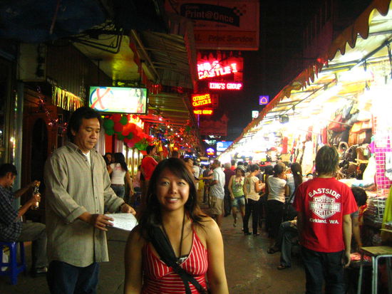 Behind me, a sex peddler flashes his 'P-Shows' card