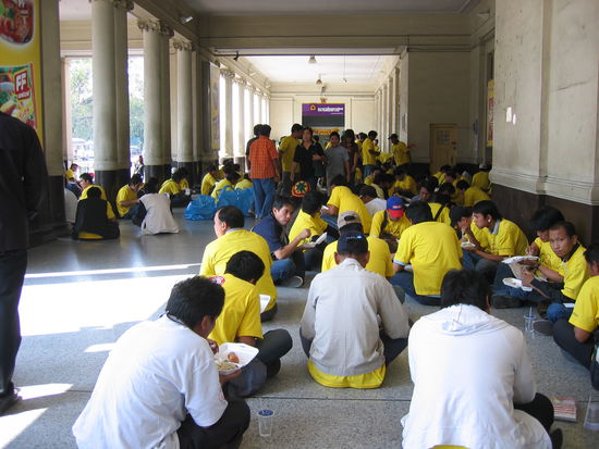 People wearing yellow shirts in celebration of the King's 60th year in reign