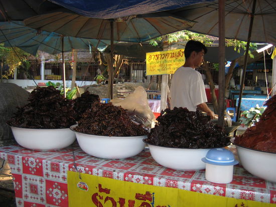 Marinated raw meat...with flies swarming around it