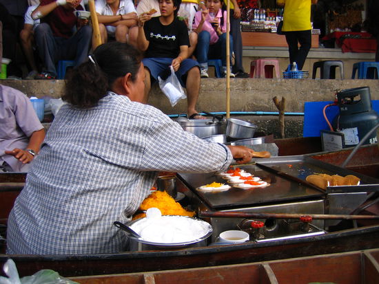This lady makes a Thai dessert, shaped like a taco