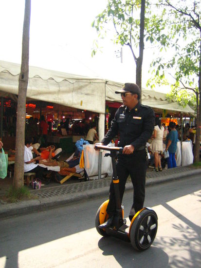 A Thai policeman patrols around