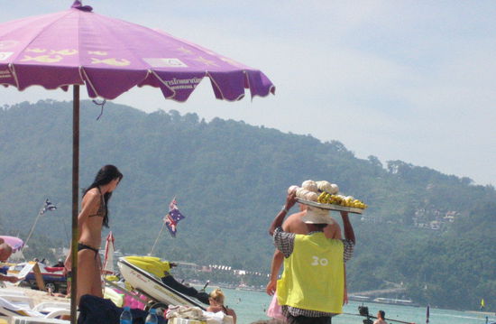 One of the people selling their goods-- the price (in baht) is written on the back of his jersey