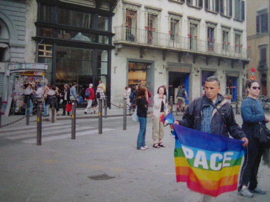 This guy holds up a flag symbolizing peace