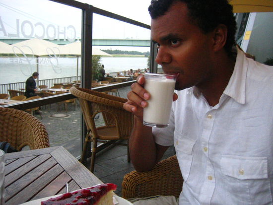 Adam takes a sip of his creamer