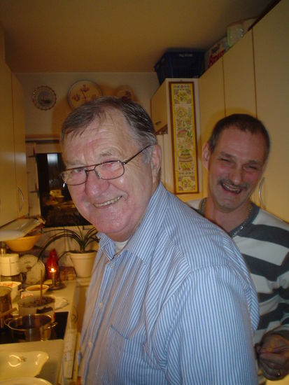 Bent in his tiny kitchen with his son-in-law