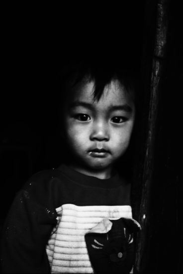 This boy was looking out of his house. He has a drop of drool on the right side of his lip. Colour Slide converted to Black and White.