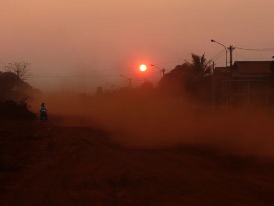 dusty road in Banlung at sunset