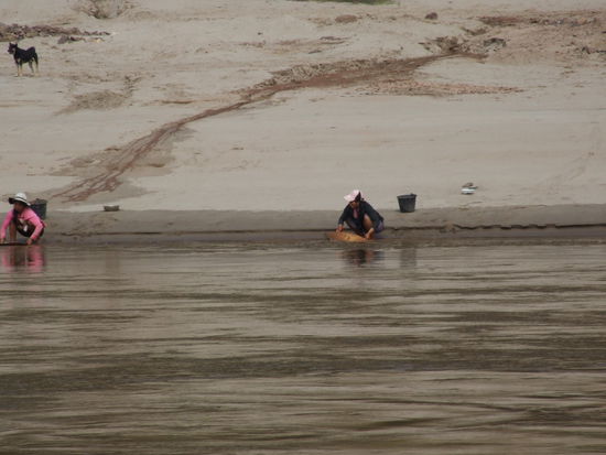 Ladies washing gold on the banks of the Mekong