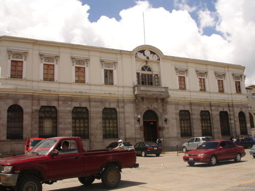 ...Banco Occidental. Security guard at the door...