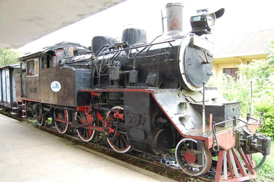 an abandoned French railway station with a steam locomotive,