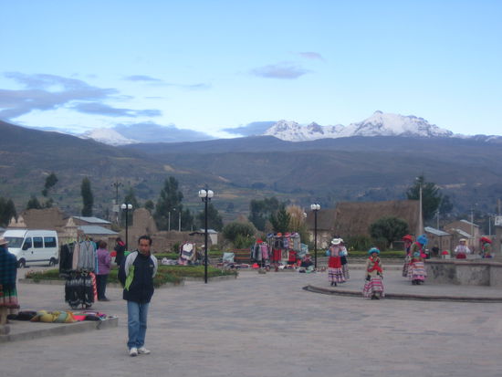 Scene at the market place at 6.40am. Vendors are selling and school girls are dancing for the tourists.