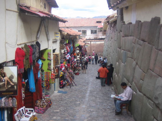 The 12-cornered stone on the right, and where tourists, there vendors...
