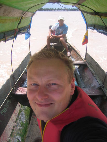 Sitting in a taxi across the river.
