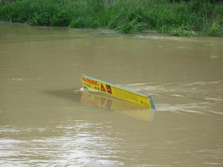 innocent looking sign at the flooded roadside...