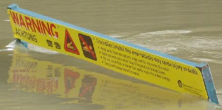 ...on closer inspection it tells you not to swim as crocodiles inhabit this area