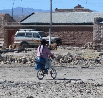 a typical bolivian woman (on a rather small bike)