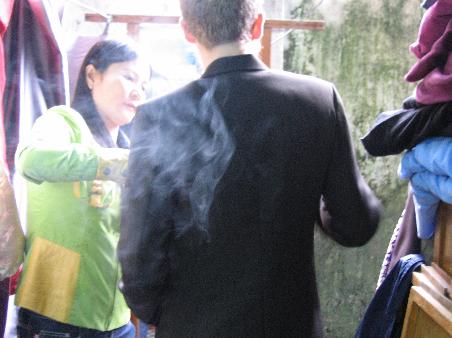 check out the beautifully moody shot catherine got of my suit fitting. thanks for smoking, smoking guy.
