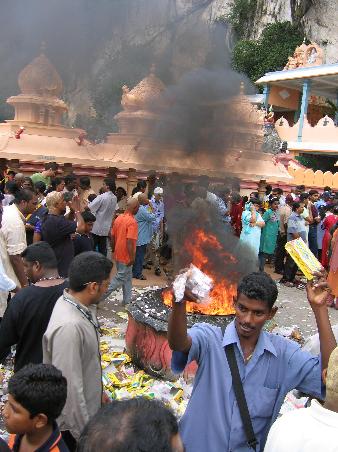 He's selling camphor tablets to throw in the fire. Quite the smell, but I'm not sure about the environmental effects of such a thing.